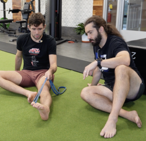 Dr. John working with Rene on how to strengthen his feet for BJJ